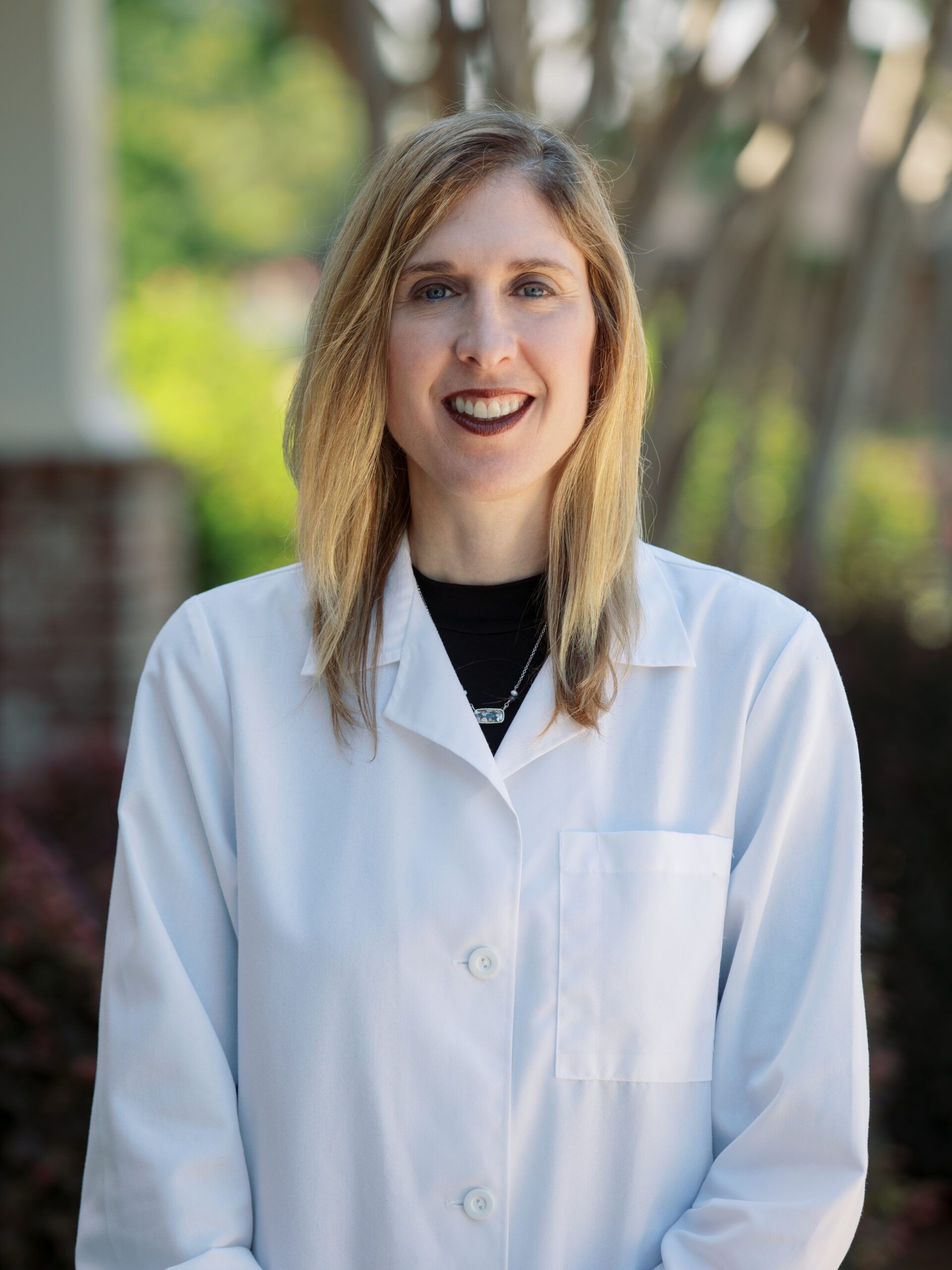 Dr. Heather Newlon in a lab coat.