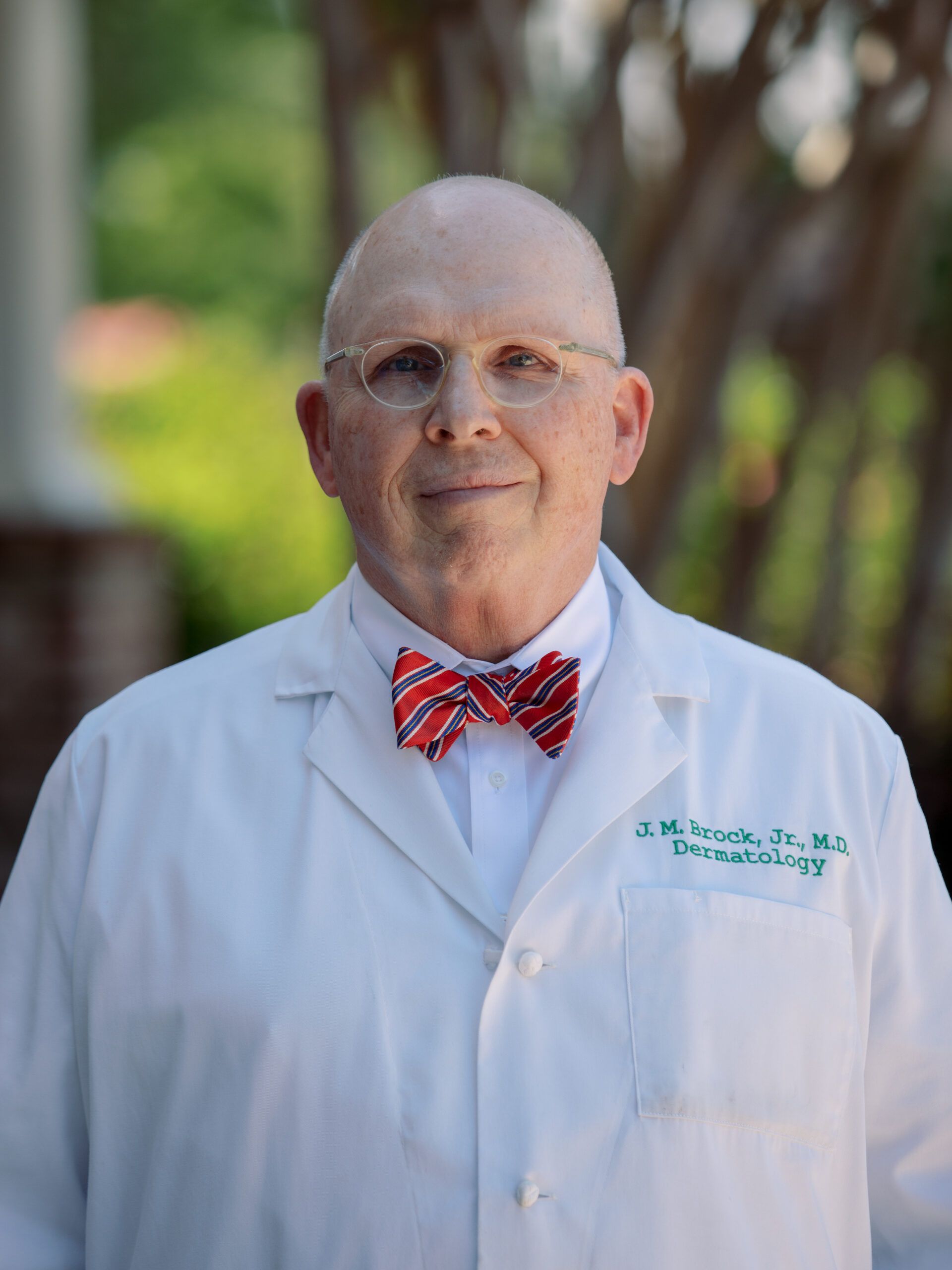 Dr. James Brock in white medical coat with red bow tie